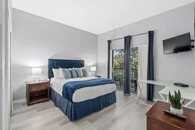 a bedroom with a bed and a desk and a television at Finding Nemo House at Caribe Cove Resort - Sage Vacations in Kissimmee