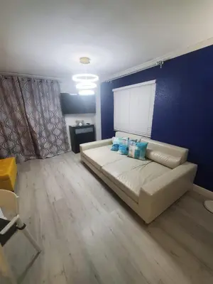 a living room with a couch and a blue wall at Universal-Disney Dream 3413 Studio - The Enclave in Orlando