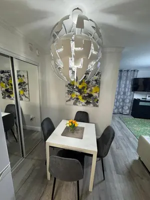 a dining room with a white table and a chandelier at Universal-Disney Dream 3413 Studio - The Enclave in Orlando