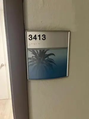 a clock on a wall with a picture of a palm tree at Universal-Disney Dream 3413 Studio - The Enclave in Orlando