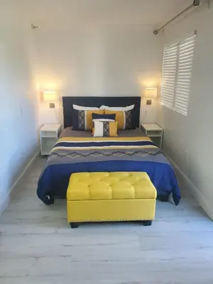 a bedroom with a yellow bed and a yellow couch at Universal-Disney Dream 3413 Studio - The Enclave in Orlando