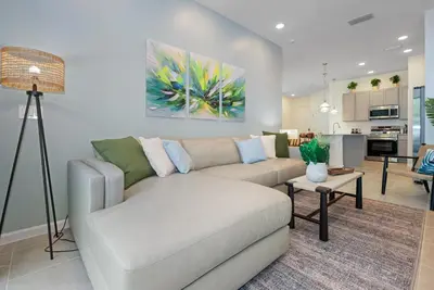 a living room with a couch and a table at 10251 EBB Tide Lane in Orlando