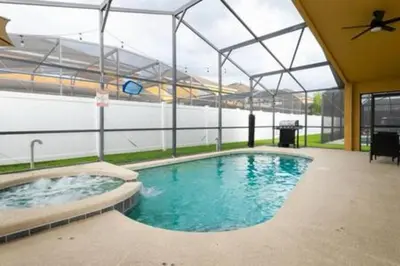a large swimming pool in a building with a ceiling at 4 Bedroom with Pool near to Disney in Kissimmee