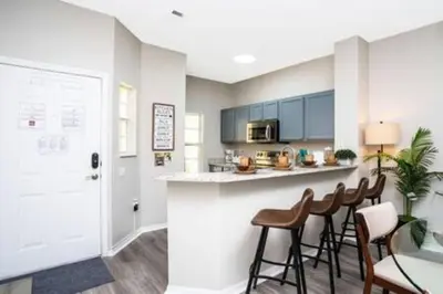 a kitchen with a counter and stools in a room at Emerald Island Resort townhouse 3 Bedrooms in Kissimmee