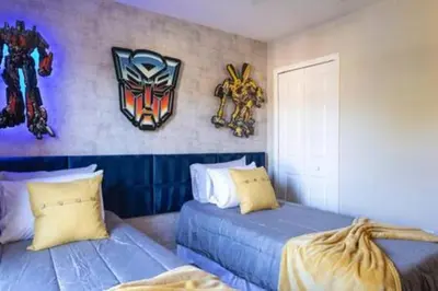 a bedroom with two beds and a mask on the wall at Emerald Island Resort townhouse 3 Bedrooms in Kissimmee