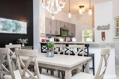 a kitchen and dining room with a table and chairs at 3 Bedrooms Home W Pool just 6 miles from Disney in Kissimmee