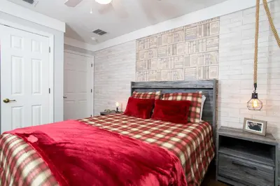 a bedroom with a red bed with a red blanket at 3 Bedrooms Home W Pool just 6 miles from Disney in Kissimmee