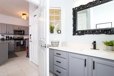 a bathroom with a sink and a mirror on the wall at 3 Bedrooms Home W Pool just 6 miles from Disney in Kissimmee