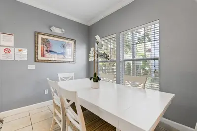 a white dining room with a white table and chairs at Perfect Gateway to Disney 9108 in Kissimmee