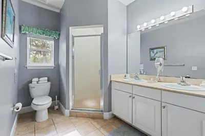 a bathroom with a toilet and two sinks and a shower at Perfect Gateway to Disney 9108 in Kissimmee