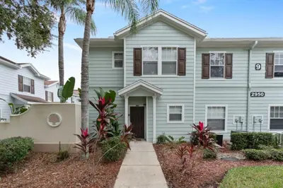 a house with palm trees in front of it at Perfect Gateway to Disney 9108 in Kissimmee