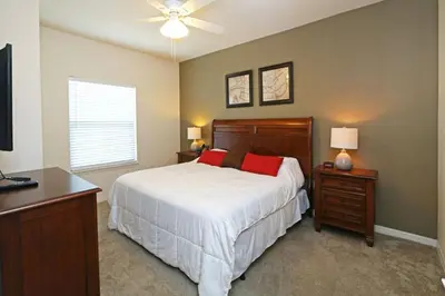a bedroom with a bed and a ceiling fan at Your VIP Home near Disney 25107 in Kissimmee