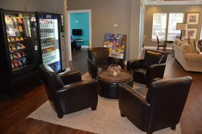 a living room with leather chairs and a soda machine at Your VIP Home near Disney 25107 in Kissimmee