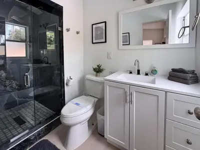 a bathroom with a shower and a toilet and a sink at Exquisite Luxury Villa with Pool in Prime Location in Orlando