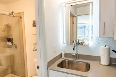 a bathroom with a sink and a mirror at Modern 1BED 1BA Gem in Great Location Free Parking in Kissimmee