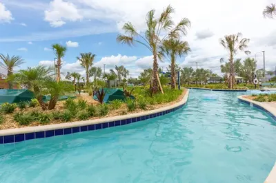 a swimming pool with palm trees in a resort at Your 5BDR house with pool - 4959 in Kissimmee