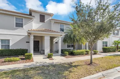 a house with a tree in front of it at Amazing 4BDR with pool near Disney - 4914 in Kissimmee