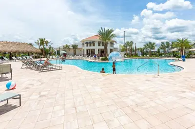 a large swimming pool with a child playing in it at Your 4BDR Vacation Home - 4838 in Kissimmee