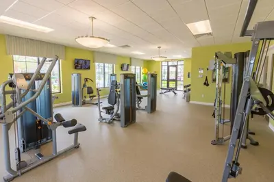 a gym with treadmills and machines in a room at Your 4BDR Vacation Home - 4838 in Kissimmee