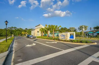 a street with a car parked on the side of a road at Casa Temática c/ Piscina no Storey Lake in Kissimmee