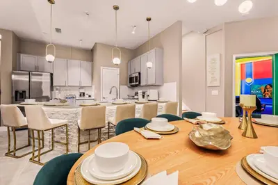 a kitchen and dining room with a table and chairs at Luxury Stay Walk to SeaWorld Minions Room in Orlando