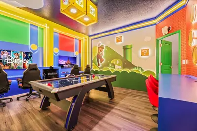 a room with a ping pong table in a room at Luxury Stay Walk to SeaWorld Minions Room in Orlando