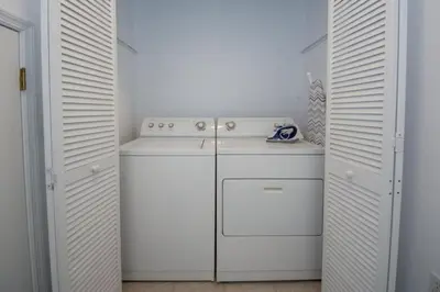a kitchen with white cabinets and a white stove at Villa Bella - 4 Bedrooms in Kissimmee