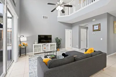 a living room with a couch and a tv at Family Fun Kissimmee Retreat in Kissimmee