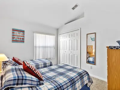 a bedroom with two beds and a window at Sunny Getaway with Private Pool, Spa & Fenced Yard in Kissimmee