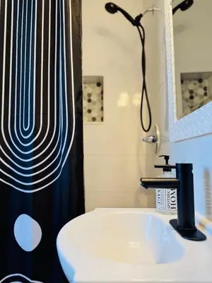 a bathroom with a sink and a shower at 3BR Oasis DT ORL, Full Kitchen & Fenced Yard! in Orlando