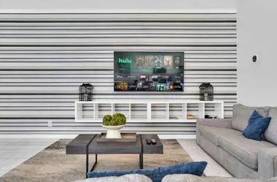 a living room with a flat screen tv on a wall at 5BR Kissimmee Home Pool and Game Room Fun in Kissimmee