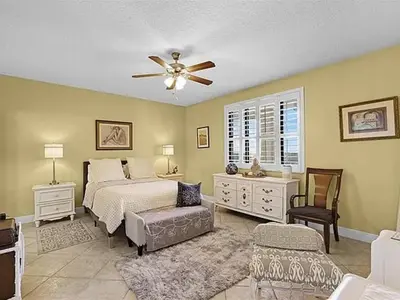 a bedroom with a bed and a ceiling fan at Spacious Lakefront Condo in Kissimmee in Kissimmee