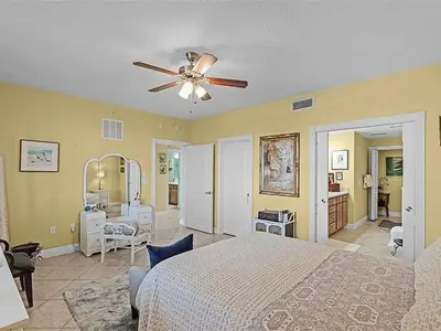 a bedroom with a bed and a ceiling fan at Spacious Lakefront Condo in Kissimmee in Kissimmee