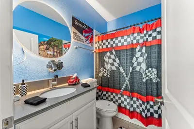 a bathroom with a checkered shower curtain and a sink at 2817 Storey Lake Kissimmee in Kissimmee