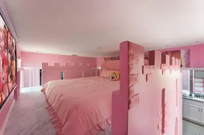 a pink bedroom with a large bed in it at 2817 Storey Lake Kissimmee in Kissimmee
