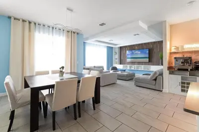a dining room and living room with a table and chairs at 2817 Storey Lake Kissimmee in Kissimmee
