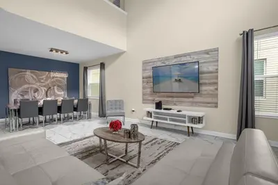 a living room with a white couch and a table at Disney Vacation Villa Pool & BBQ & Resort Clubhouse in Kissimmee
