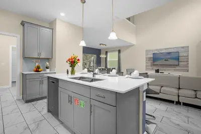 a large kitchen with a sink and a couch at Disney Vacation Villa Pool & BBQ & Resort Clubhouse in Kissimmee