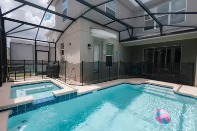 a large swimming pool with a volley ball in it at Fantasy Stay in 5 bed at Storey Lake in Kissimmee