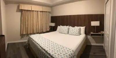 a bedroom with a large white bed with pillows at Universal-Disney Dream 606S - 1 Bedroom in Orlando