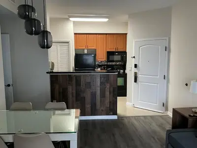 a living room with a kitchen with a counter top at Universal-Disney Dream 606S - 1 Bedroom in Orlando