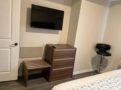 a bedroom with a dresser with a television on the wall at Universal-Disney Dream 606S - 1 Bedroom in Orlando