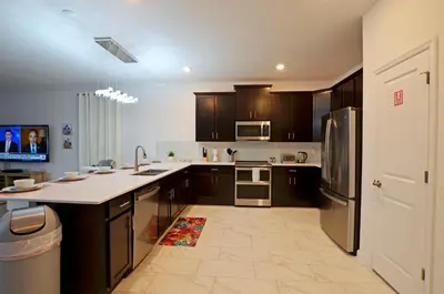 a kitchen with wooden cabinets and a counter top at 4213 - Lakeside Retreat in Kissimmee