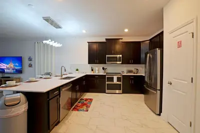 a kitchen with wooden cabinets and a large kitchen island at 4213 - Lakeside Retreat in Kissimmee