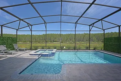 an indoor swimming pool with a roof at 2956 - Sanctuary at Storey Lake in Kissimmee
