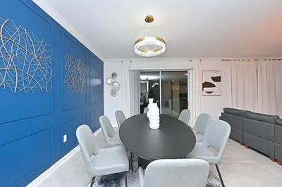 a dining room with blue walls and a table and chairs at 2956 - Sanctuary at Storey Lake in Kissimmee