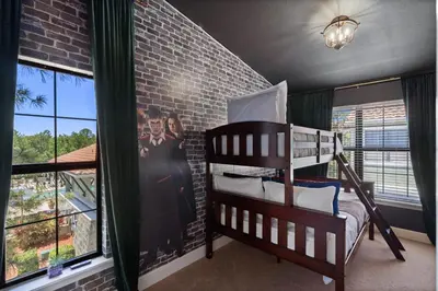 a bedroom with two bunk beds and a brick wall at 14531 Damai in Orlando