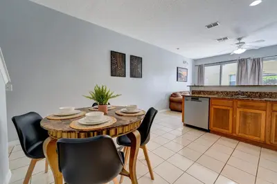 a kitchen and dining room with a table and chairs at Comfy Townhome Minutes from Disney in Orlando