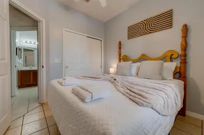 a bedroom with a large bed with towels on it at Comfy Townhome Minutes from Disney in Orlando