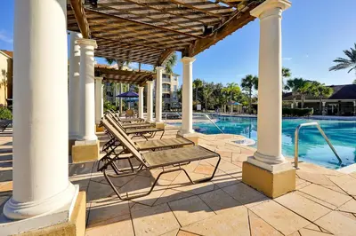 a patio with chairs and a swimming pool at Spring Break Awaits Disney Close Pool Slides Fun in Orlando
